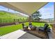 Covered outdoor patio featuring comfortable seating around a cozy fire pit with mountain views at 188 S Rogers Way, Golden, CO 80401