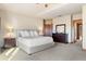 Large bedroom features natural lighting, neutral walls, carpet, and a ceiling fan at 6928 S Eaton St, Littleton, CO 80128