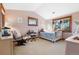 Bedroom with pink walls, natural wood trim, large windows, and light-colored carpet at 6928 S Eaton St, Littleton, CO 80128