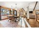 Open dining area with hardwood floors, modern lighting, and an adjacent living area at 6928 S Eaton St, Littleton, CO 80128