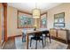 Cozy dining area features large windows offering plenty of natural light and backyard views at 6928 S Eaton St, Littleton, CO 80128