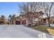 Stately home with a three-car garage, stone accents, and mature landscaping at 6928 S Eaton St, Littleton, CO 80128