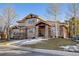 Charming two-story house boasting a stone accent exterior, an inviting entryway, and well-maintained landscaping at 6928 S Eaton St, Littleton, CO 80128