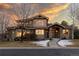 Beautiful two-story home featuring a stone facade, tasteful landscaping, and a warm, inviting entrance at 6928 S Eaton St, Littleton, CO 80128