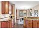 Updated kitchen adjacent to the dining area includes granite countertops and wooden cabinetry at 6928 S Eaton St, Littleton, CO 80128