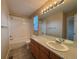 Bright bathroom with a shower-tub combo, and a vanity with a large mirror at 10027 Sylvestor Rd, Highlands Ranch, CO 80129