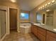 Bathroom featuring a soaking tub, vanity with sink, and a glass-enclosed shower at 10027 Sylvestor Rd, Highlands Ranch, CO 80129