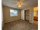 Bedroom with a ceiling fan, closet, and an attached bathroom entrance at 10027 Sylvestor Rd, Highlands Ranch, CO 80129