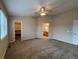 Spacious bedroom featuring carpet, ceiling fan, and doorways to closet and bath at 10027 Sylvestor Rd, Highlands Ranch, CO 80129