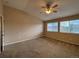 Bedroom with carpet, ceiling fan, and double windows providing ample natural light at 10027 Sylvestor Rd, Highlands Ranch, CO 80129