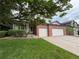 Charming two-story home featuring a brick facade, two-car garage, and well-maintained lawn and shrubbery at 10027 Sylvestor Rd, Highlands Ranch, CO 80129