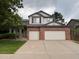 Two-story home featuring a brick facade and a spacious three-car garage at 10027 Sylvestor Rd, Highlands Ranch, CO 80129