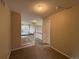 Well-lit hallway featuring neutral tones, carpet flooring, and a glimpse of natural light from a window at 10027 Sylvestor Rd, Highlands Ranch, CO 80129