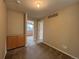Carpeted area showcasing a built-in cabinet and a view into another room with natural light at 10027 Sylvestor Rd, Highlands Ranch, CO 80129