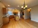 Bright kitchen with wood floors, a center island, and stainless steel appliances at 10027 Sylvestor Rd, Highlands Ranch, CO 80129