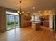 Bright kitchen with wood floors, a center island, and stainless steel appliances at 10027 Sylvestor Rd, Highlands Ranch, CO 80129