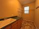 Functional laundry room with a utility sink, counter space, and shelving at 10027 Sylvestor Rd, Highlands Ranch, CO 80129