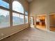 Bright living room open to kitchen features vaulted ceilings and large windows at 10027 Sylvestor Rd, Highlands Ranch, CO 80129