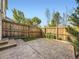 Private fenced backyard features a concrete patio and low-maintenance artificial turf at 12265 E 2Nd Dr, Aurora, CO 80011