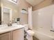Bathroom showcasing a shower-tub combo, single sink vanity, and calming decor at 12265 E 2Nd Dr, Aurora, CO 80011