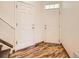 Inviting entryway with wood-look flooring and a front door with transom window and coat closet at 12265 E 2Nd Dr, Aurora, CO 80011
