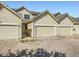 Exterior of townhomes with attached garages and well-maintained landscaping at 12265 E 2Nd Dr, Aurora, CO 80011
