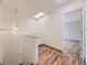 Bright hallway with skylight and laminate flooring, enhancing natural light at 12265 E 2Nd Dr, Aurora, CO 80011