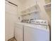 Laundry room featuring a full-size washer and dryer, storage shelves and closet at 12265 E 2Nd Dr, Aurora, CO 80011