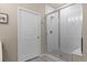 Clean bathroom with walk-in shower and tile surround at 155 S Monaco Pkwy # 114, Denver, CO 80224