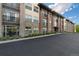 Brick building exterior with balconies and landscaping at 155 S Monaco Pkwy # 114, Denver, CO 80224