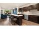 Modern open-concept kitchen with island and stainless steel appliances at 155 S Monaco Pkwy # 114, Denver, CO 80224