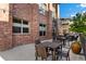 Community patio with tables and chairs for residents to enjoy at 155 S Monaco Pkwy # 114, Denver, CO 80224