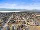 Aerial of a neighborhood with mountains and a lake in the background, taken on a clear day at 4621 S Perry Way, Denver, CO 80236