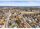 Aerial view of residential area, featuring well-kept homes, streets, and vegetation at 4621 S Perry Way, Denver, CO 80236