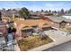 Aerial view of a well-maintained brick house with a manicured lawn and a two car garage at 4621 S Perry Way, Denver, CO 80236