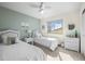 Bright bedroom featuring twin beds, a ceiling fan and plenty of natural light at 4621 S Perry Way, Denver, CO 80236