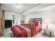 Bedroom featuring neutral carpet, a bed with colorful pillows, and access to other rooms at 4621 S Perry Way, Denver, CO 80236