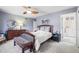 Bedroom with gray walls, a wooden bed frame, and ample natural light at 4621 S Perry Way, Denver, CO 80236