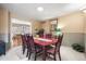 Traditional dining room with cherry wood table and chairs, and views into kitchen at 4621 S Perry Way, Denver, CO 80236