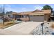 Charming ranch style home with a brick facade, well-kept lawn, and a two-car garage at 4621 S Perry Way, Denver, CO 80236