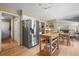 Bright kitchen featuring stainless steel appliances, a movable island, and a seamless flow to dining area at 4621 S Perry Way, Denver, CO 80236