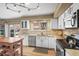 Modern kitchen featuring granite countertops, stainless steel appliances, and lots of natural light at 4621 S Perry Way, Denver, CO 80236