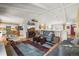 Open-concept living room featuring vaulted ceilings and seamless flow into the kitchen at 4621 S Perry Way, Denver, CO 80236