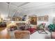Open-concept living room with vaulted ceilings, a ceiling fan, and views into dining room at 4621 S Perry Way, Denver, CO 80236