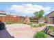 Brick paved backyard featuring mature landscaping, brick outdoor fireplace, and perimeter privacy fencing at 3580 Locust St, Denver, CO 80207