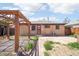 Backyard featuring a pergola sitting area, and a brick paved walkway to the home's entrance at 3580 Locust St, Denver, CO 80207