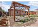 Backyard features a brick patio, a backyard pergola and a garden area at 3580 Locust St, Denver, CO 80207