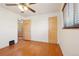Bright bedroom with hardwood floors, ceiling fan, and ample natural light at 3580 Locust St, Denver, CO 80207
