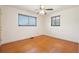 Bedroom with hardwood floors, two windows, and a ceiling fan at 3580 Locust St, Denver, CO 80207