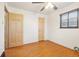 Bedroom featuring a ceiling fan, window, and hardwood flooring at 3580 Locust St, Denver, CO 80207